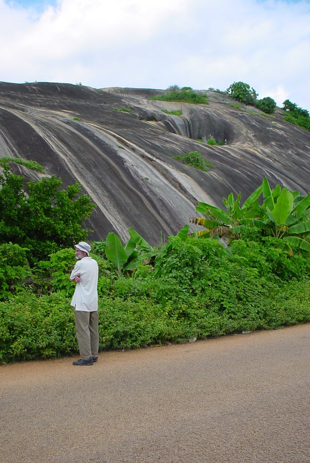 Ron Schaefer standing near a granite dome in the Northern Edo State 